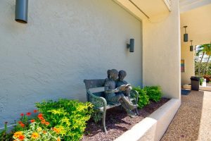 Stone statue of kids on bench image
